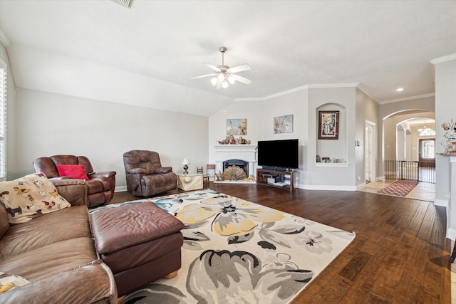 living room with crown molding, lofted ceiling, wood-type flooring, and ceiling fan