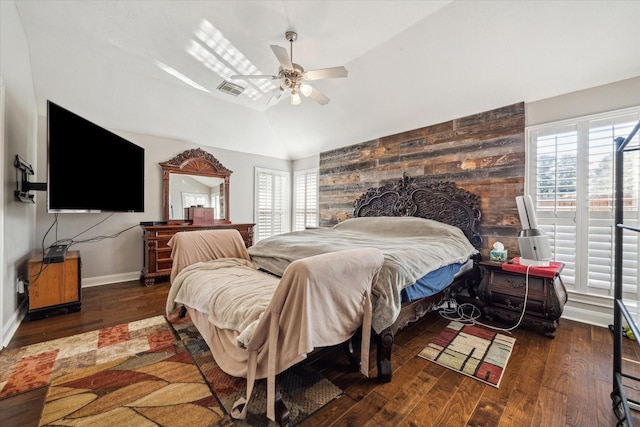 bedroom featuring multiple windows, vaulted ceiling, dark hardwood / wood-style floors, and ceiling fan