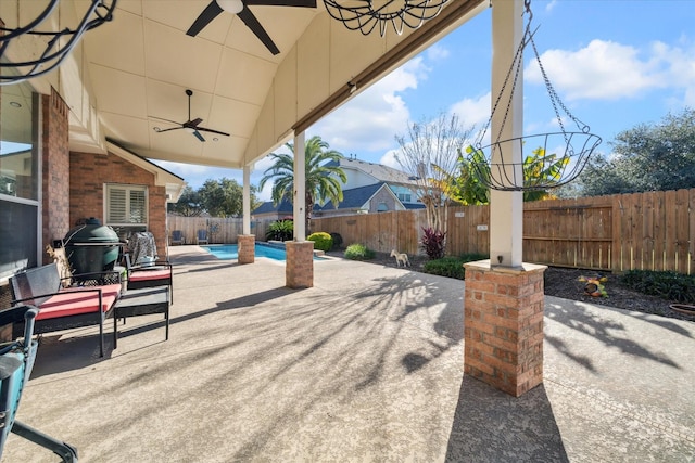 view of patio / terrace featuring a fenced in pool and ceiling fan