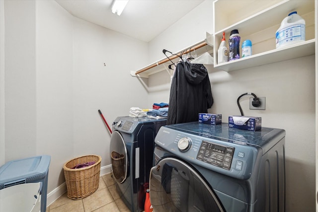 washroom with light tile patterned floors and washer and clothes dryer