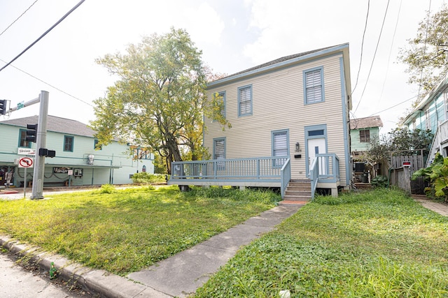 view of front of home with a front lawn and a deck