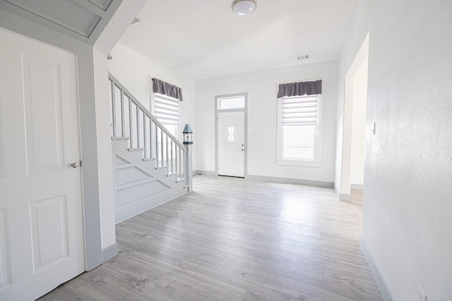 foyer with light hardwood / wood-style floors