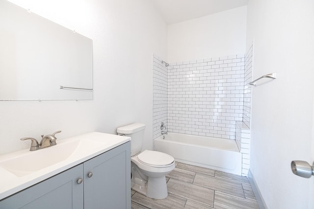 full bathroom with vanity, tiled shower / bath combo, and toilet