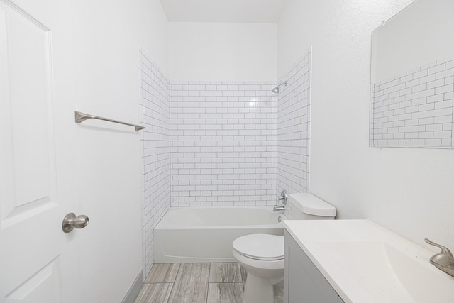 full bathroom featuring vanity, toilet, and tiled shower / bath combo