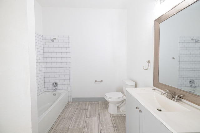 full bathroom with vanity, tiled shower / bath combo, and toilet