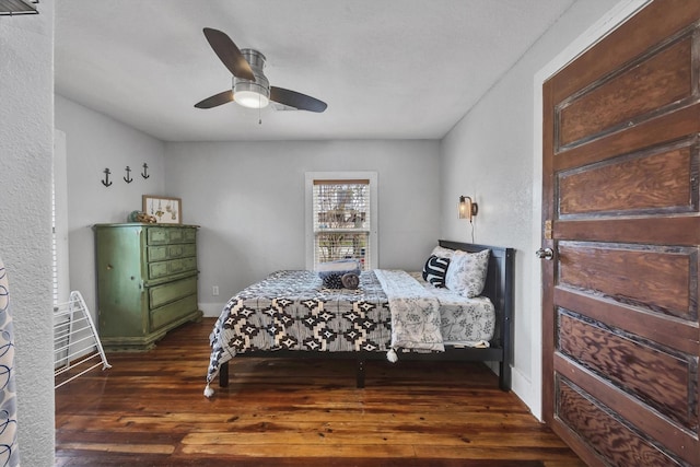 bedroom with ceiling fan and dark hardwood / wood-style flooring