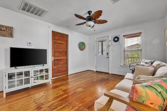 living room with wood-type flooring and ceiling fan