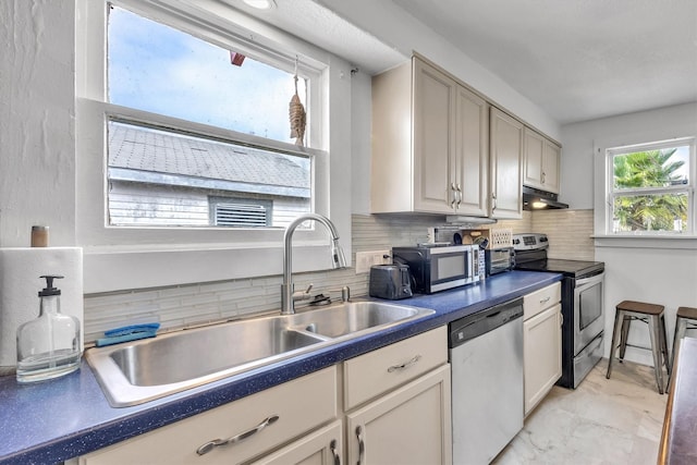 kitchen with sink, appliances with stainless steel finishes, and tasteful backsplash