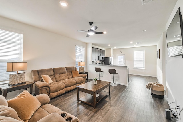 living room with recessed lighting, visible vents, dark wood-type flooring, a ceiling fan, and baseboards