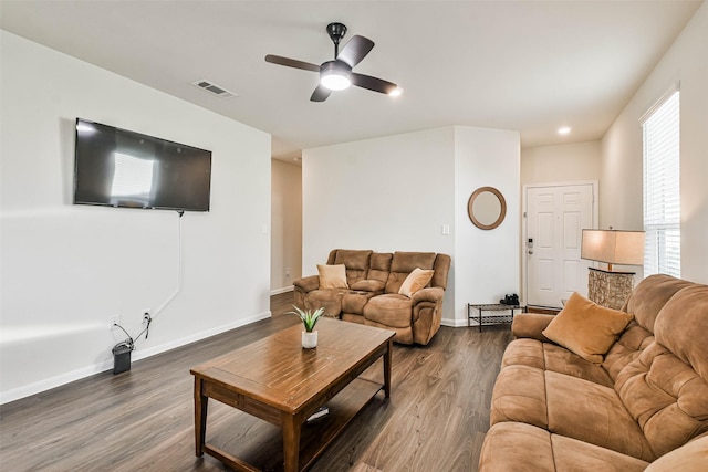 living area with a ceiling fan, dark wood finished floors, visible vents, and baseboards