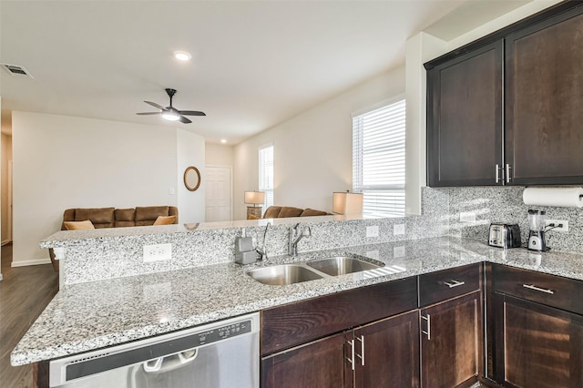 kitchen featuring a peninsula, open floor plan, and a sink