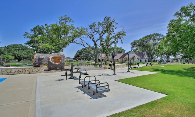 view of property's community with playground community and a yard