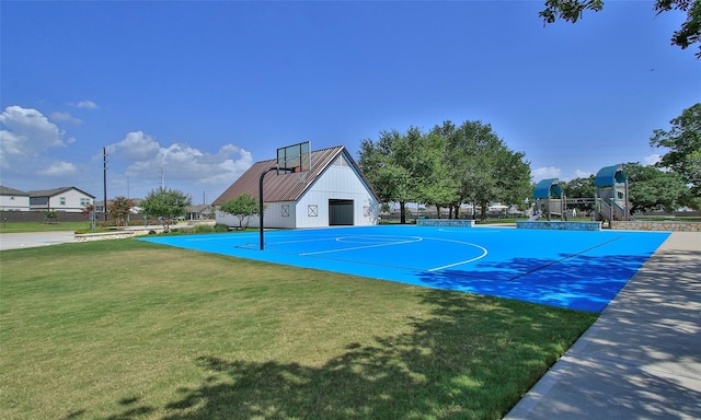 view of basketball court featuring community basketball court, a lawn, and fence