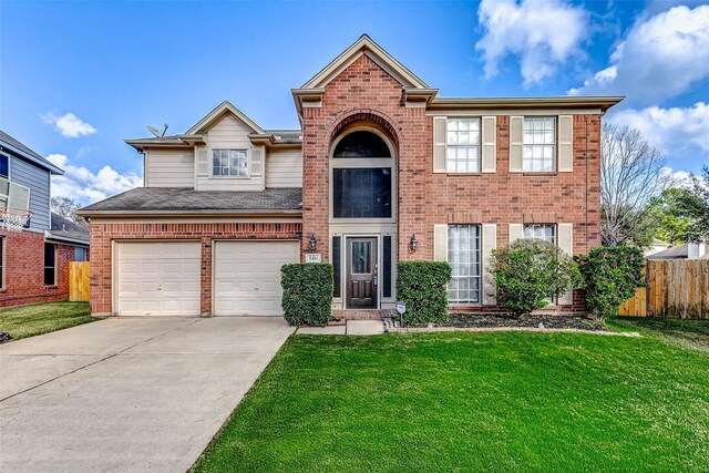 view of front of home with a garage and a front lawn