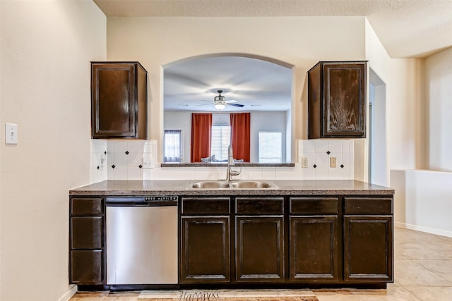 kitchen with a sink, dark countertops, dark brown cabinets, and dishwasher