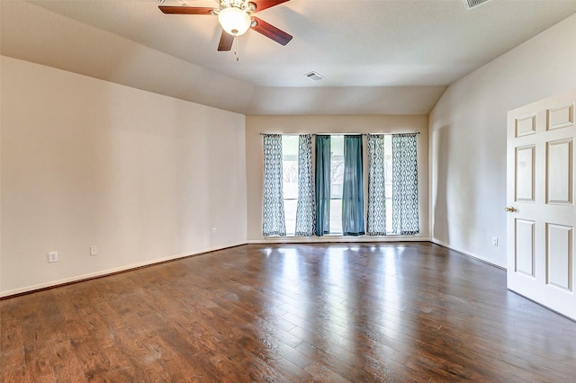 empty room with lofted ceiling, dark wood-style floors, and visible vents