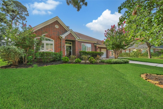 view of front of house featuring a garage and a front lawn