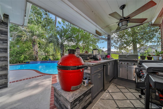 exterior space with a fenced in pool, ceiling fan, and an outdoor kitchen