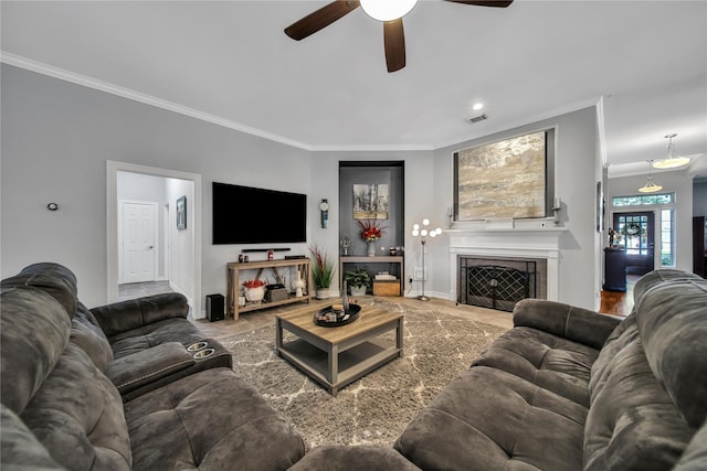 living room featuring ceiling fan and crown molding