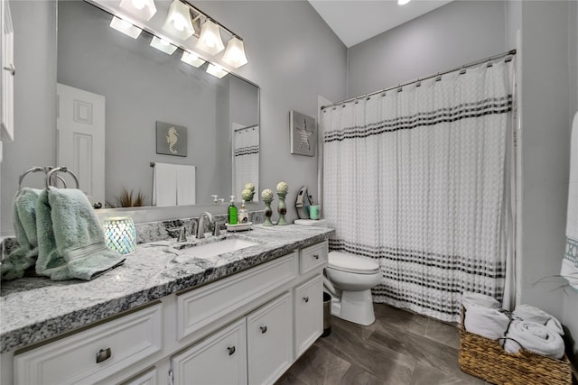 bathroom featuring vanity, curtained shower, and toilet