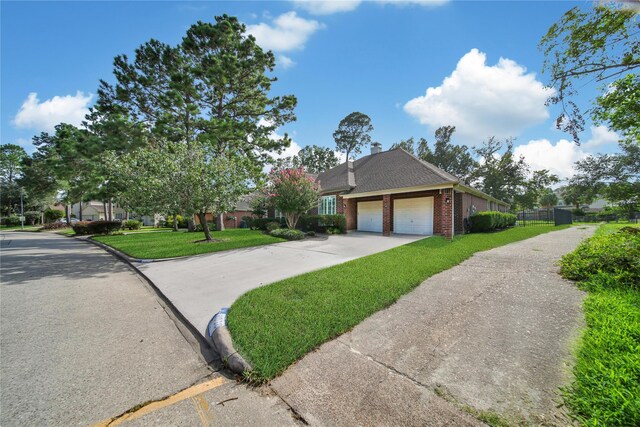 view of front of property with a front lawn and a garage