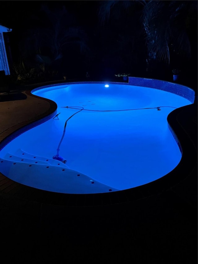 view of pool at night