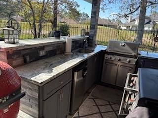 view of patio with area for grilling and sink