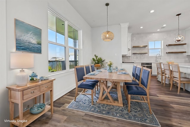 dining space featuring plenty of natural light, dark hardwood / wood-style flooring, and sink