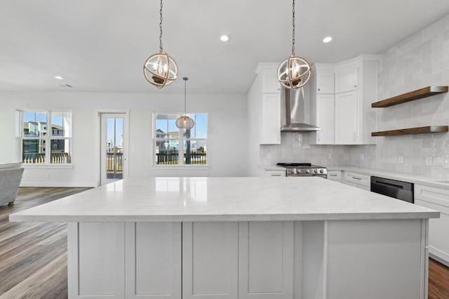 kitchen with backsplash, white cabinetry, hanging light fixtures, and stainless steel appliances