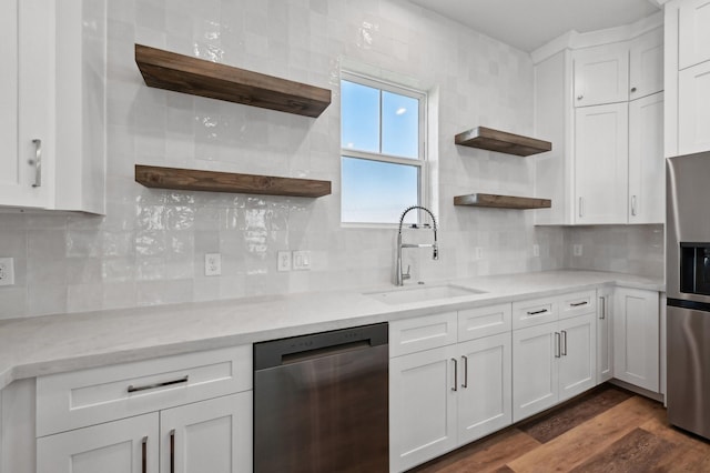 kitchen with white cabinets, dark hardwood / wood-style floors, sink, and appliances with stainless steel finishes