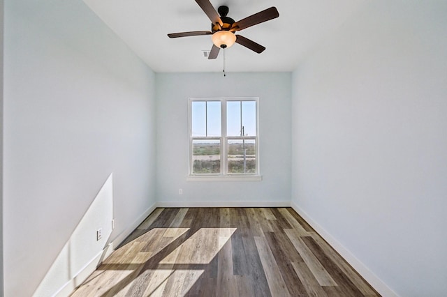 empty room featuring ceiling fan and dark hardwood / wood-style flooring