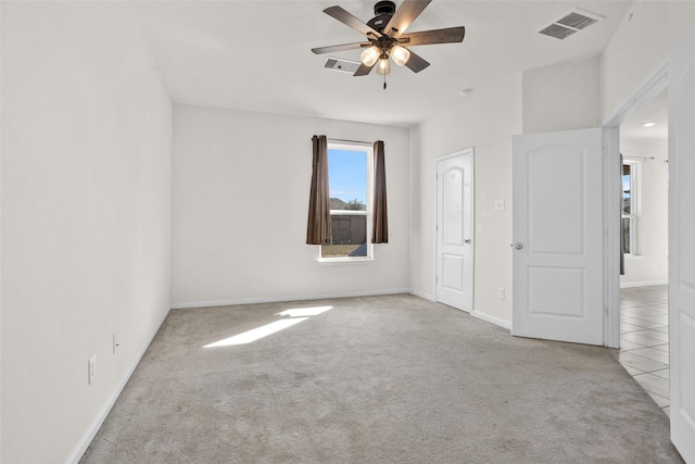 unfurnished bedroom featuring ceiling fan and light carpet