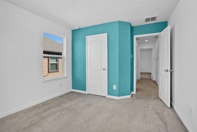 unfurnished bedroom with light colored carpet