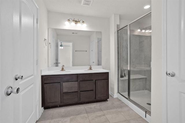 bathroom featuring tile patterned flooring, vanity, walk in shower, and ceiling fan