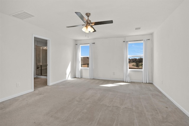 carpeted spare room featuring ceiling fan