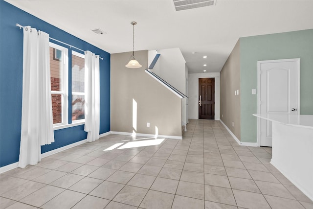 unfurnished room featuring light tile patterned floors and a wealth of natural light