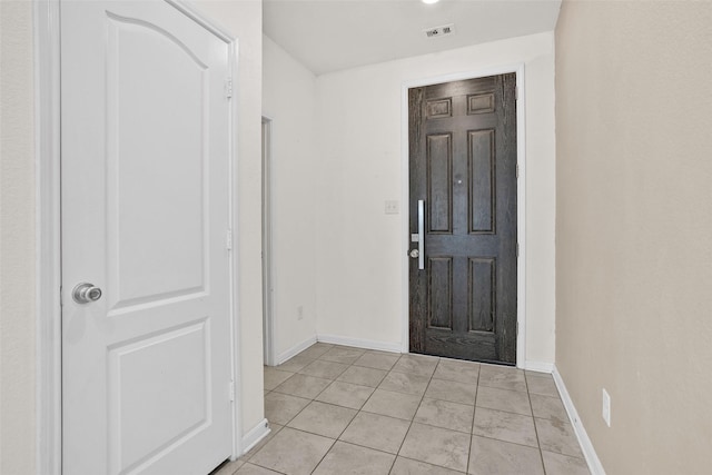 entryway with light tile patterned floors