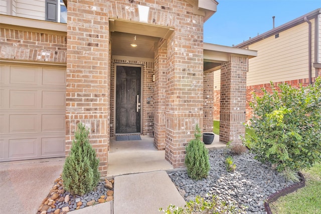 doorway to property with a garage