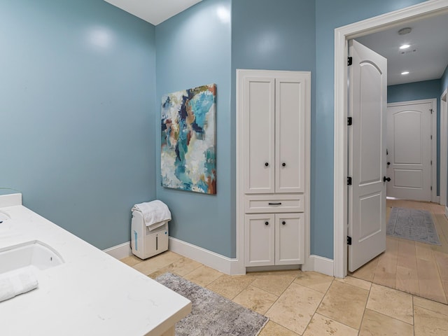 bathroom with vanity and wood-type flooring