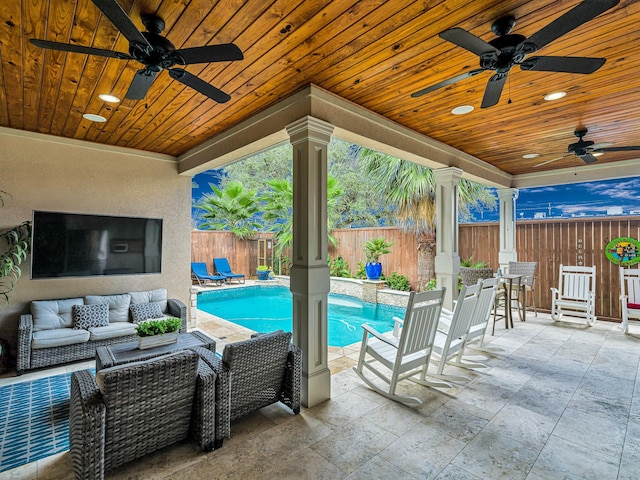 view of swimming pool featuring an outdoor living space with a fireplace, ceiling fan, and a patio area