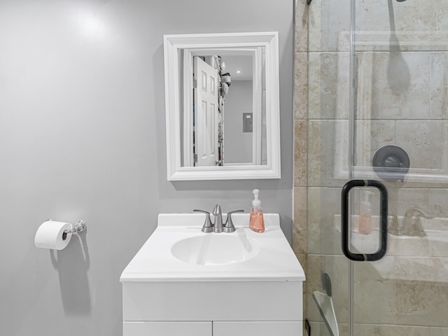 bathroom featuring vanity and a shower with shower door