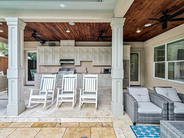 view of patio / terrace featuring ceiling fan and an outdoor kitchen