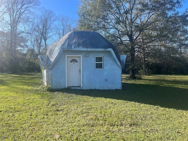 view of outdoor structure featuring a lawn