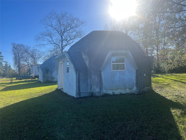 view of outbuilding featuring a yard