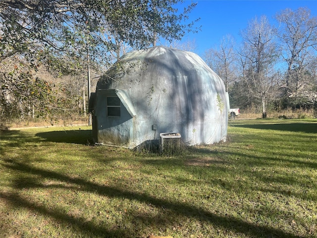 view of outbuilding with a lawn