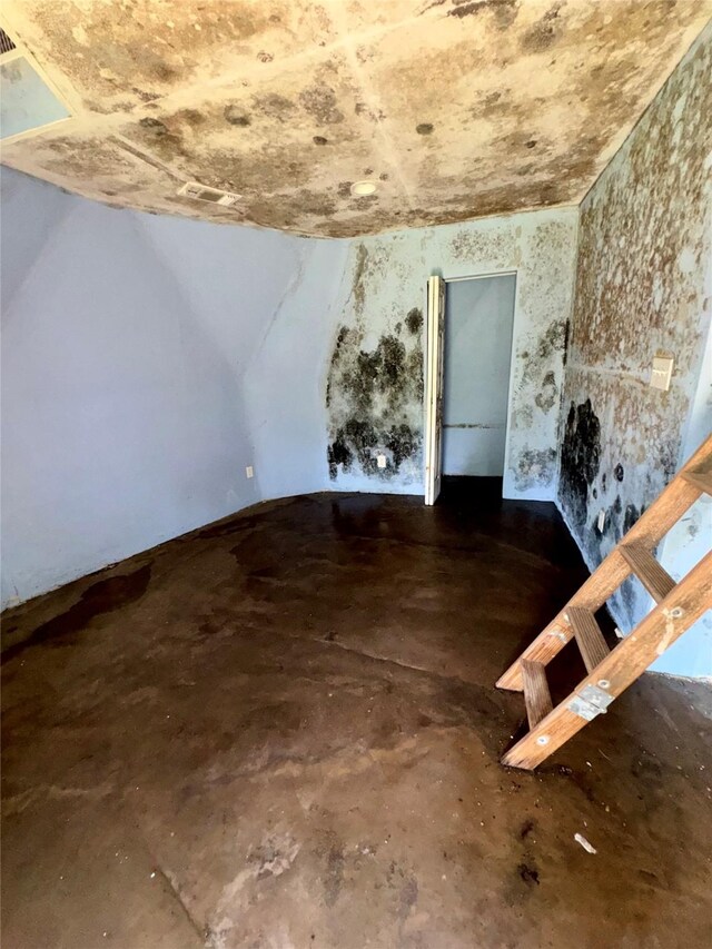362 Ole Long Pull Rd, Livingston, TX 77351 - unfurnished living room featuring concrete floors and vaulted ceiling