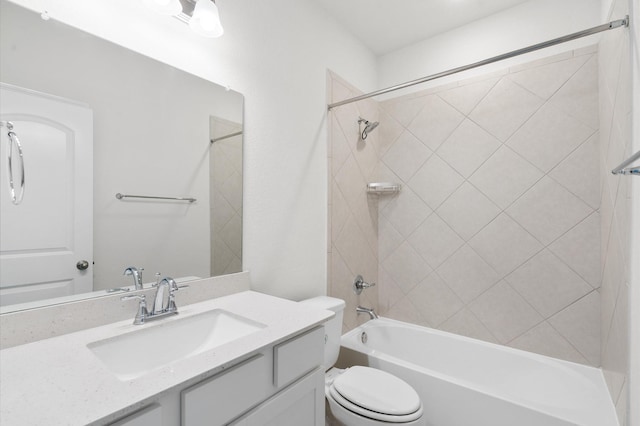 full bathroom featuring vanity, tiled shower / bath combo, and toilet