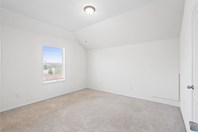 bonus room with light carpet and lofted ceiling