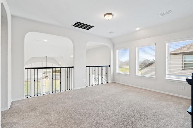 unfurnished room featuring carpet and lofted ceiling