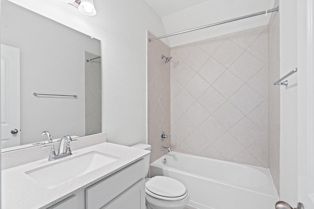 full bathroom featuring toilet, vanity, and tiled shower / bath